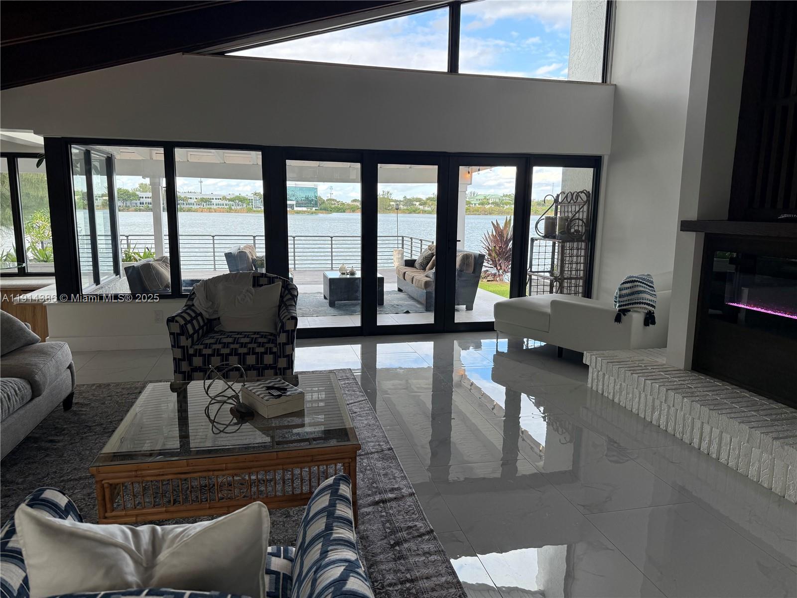 7521 Southwest 56th Street Miami, FL 33155 - Photo 16 of 34 a living room with furniture and floor to ceiling windows