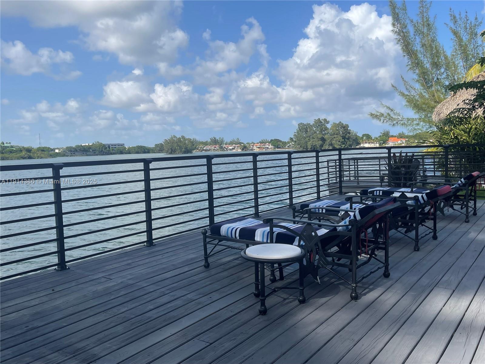 7521 Southwest 56th Street Miami, FL 33155 - Photo 17 of 34 a view of a roof deck with table and chairs with wooden floor and fence
