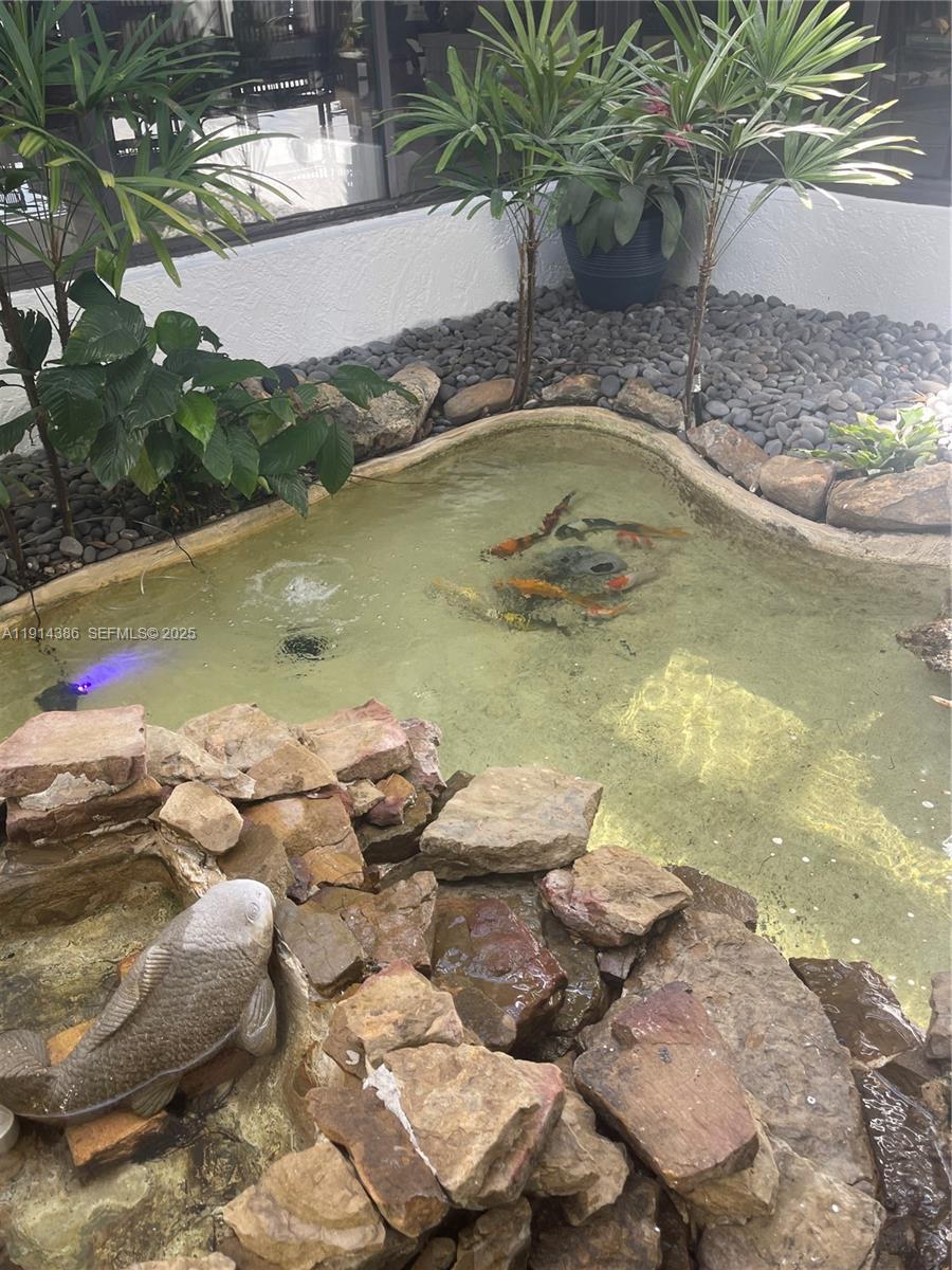 7521 Southwest 56th Street Miami, FL 33155 - Photo 20 of 34 a view of a swimming pool with lawn chairs and plants