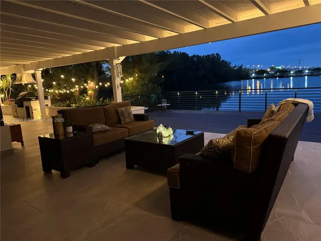 a living room with patio furniture and a fireplace