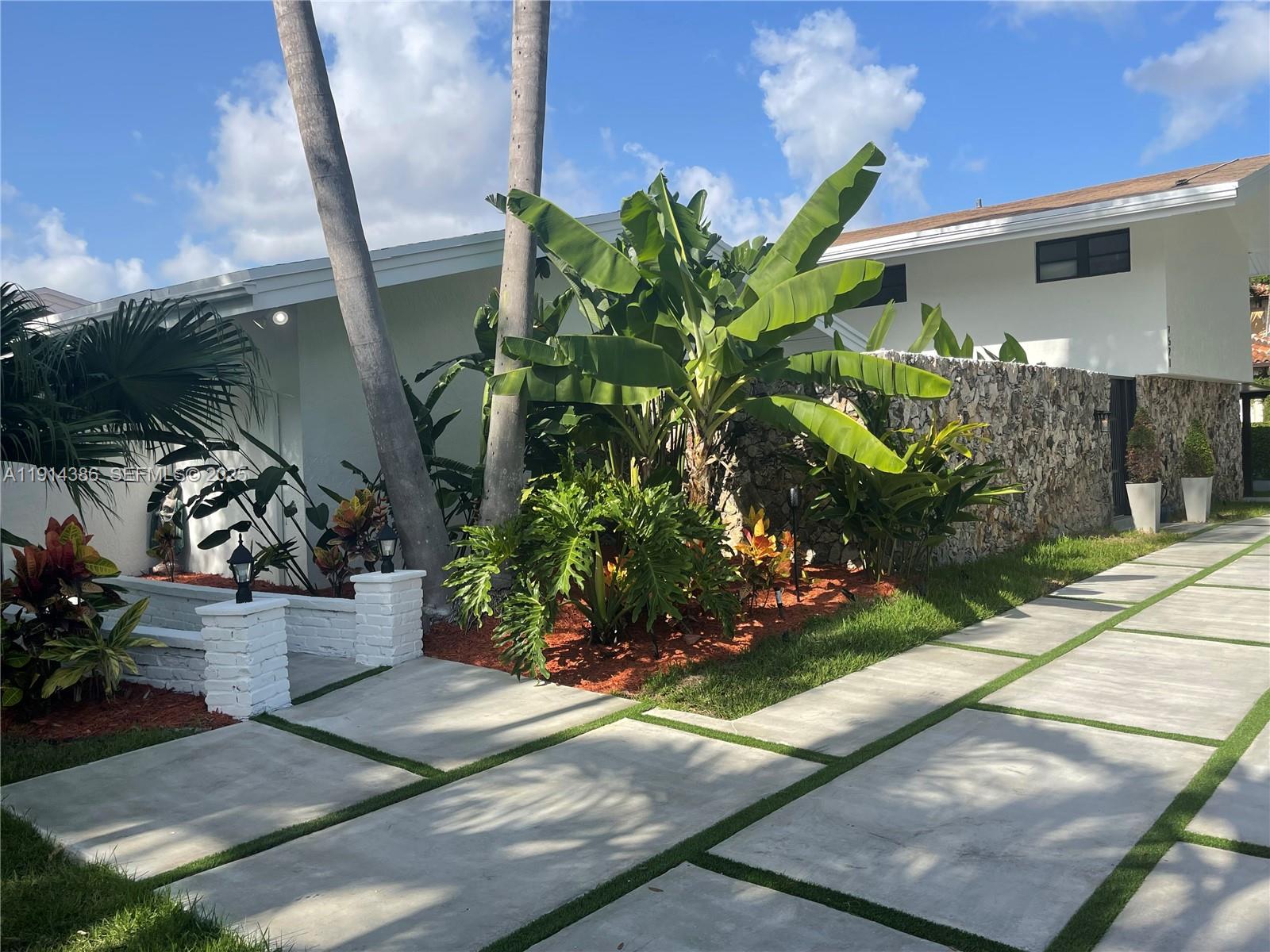 7521 Southwest 56th Street Miami, FL 33155 - Photo 31 of 34 a front view of a house with a garden