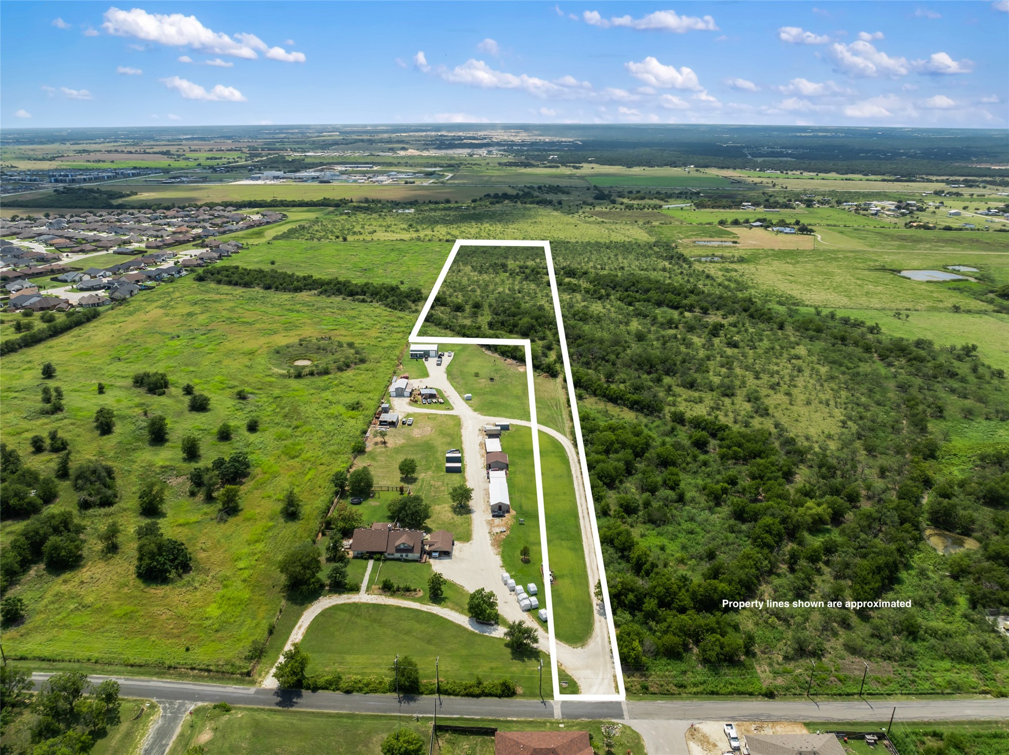 Aerial view of property and surrounding area with property boundaries highlighted