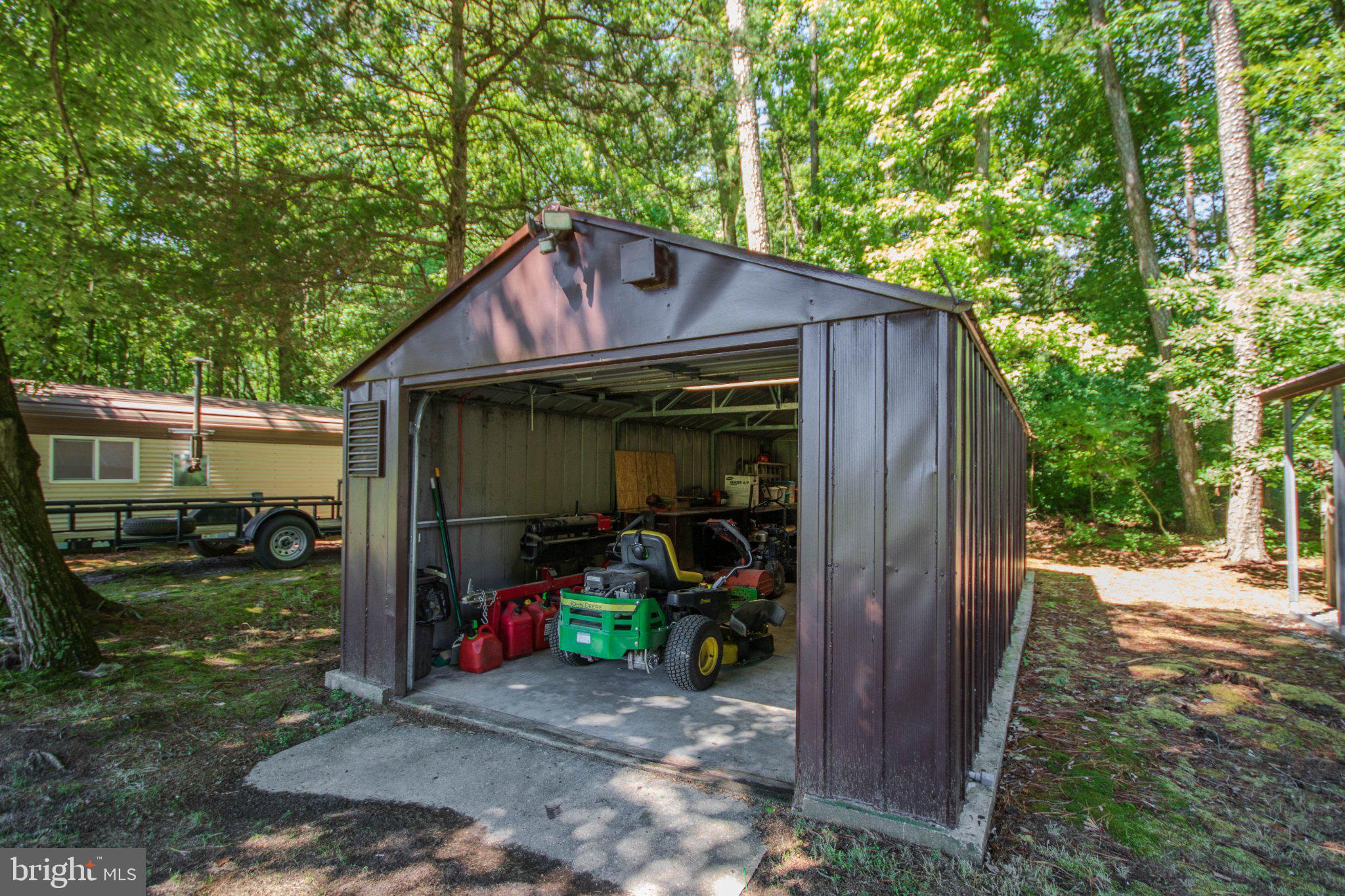 31749 Morris Leonard Road Parsonsburg, MD 21849 - Photo 37 of 40 Spacious shed nestled in lush greenery.