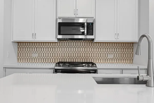 a kitchen with stainless steel appliances granite countertop a sink stove oven and refrigerator