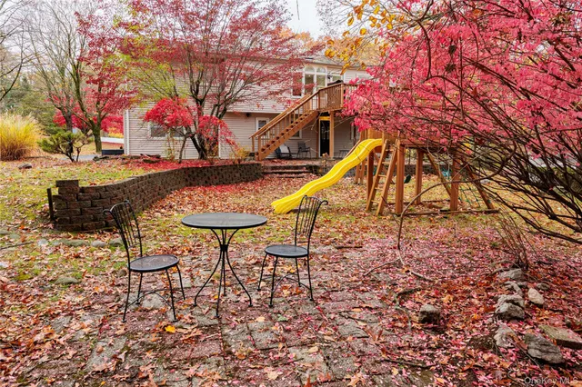 a swimming pool with outdoor seating and yard