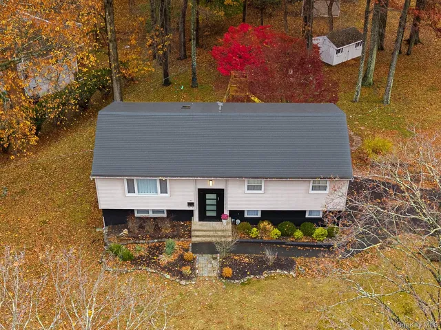 an aerial view of a house with a swimming pool