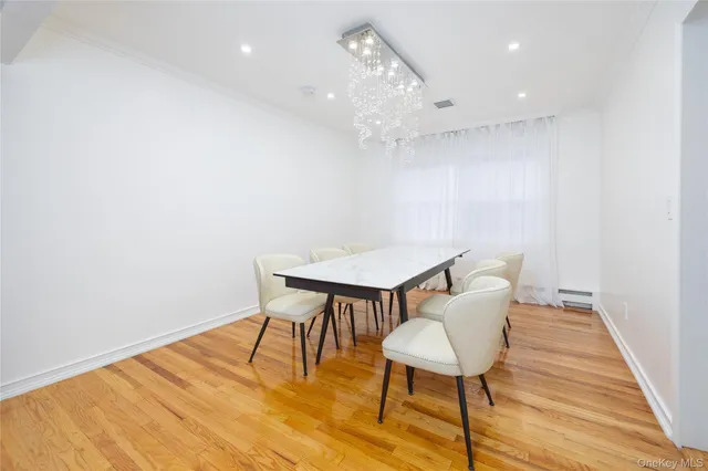 a view of a room with wooden floor and glass door