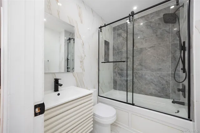 a bathroom with a shower a toilet and a sink