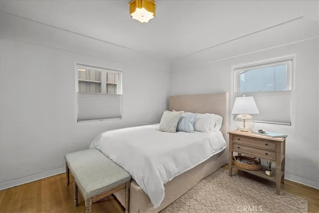 a bedroom with a bed and a night stand