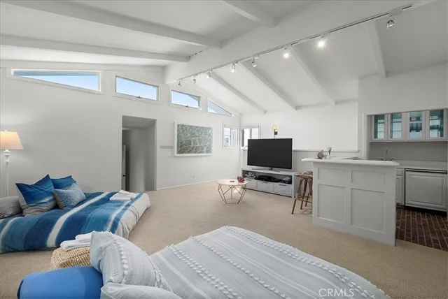 a bedroom with furniture and a flat screen tv