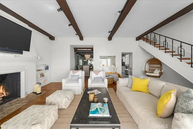 a living room with furniture fireplace and flat screen tv