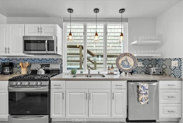 a kitchen with granite countertop a stove and a sink