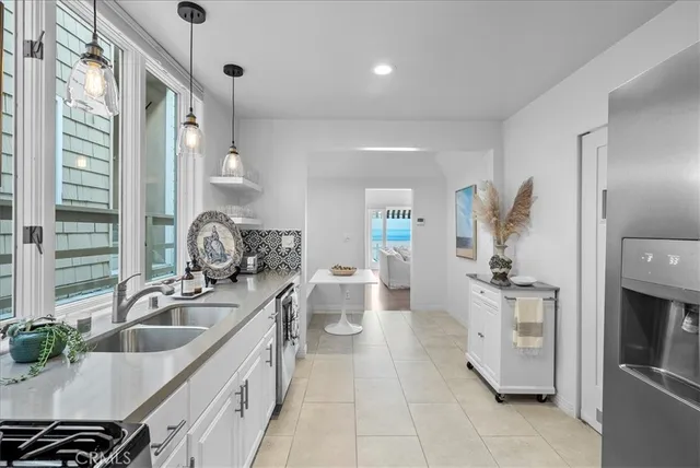 a kitchen with a sink appliances and cabinets