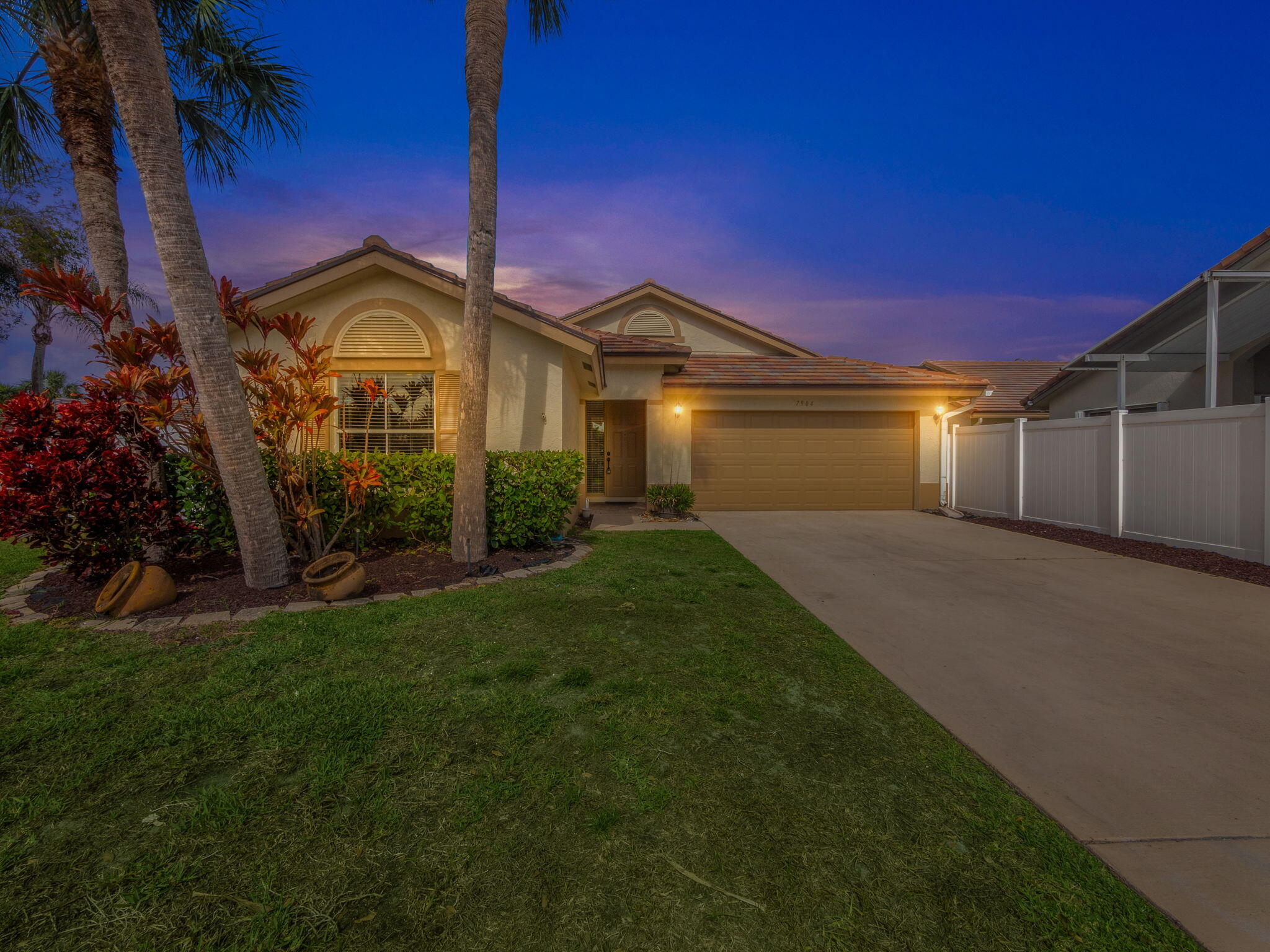7904 Manor Forest Lane Boynton Beach, FL 33436 - Photo 1 of 27 a front view of a house with garden