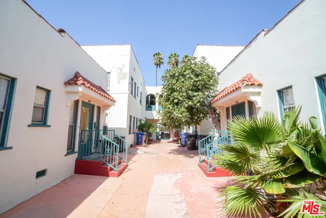 a house with palm tree in front of it