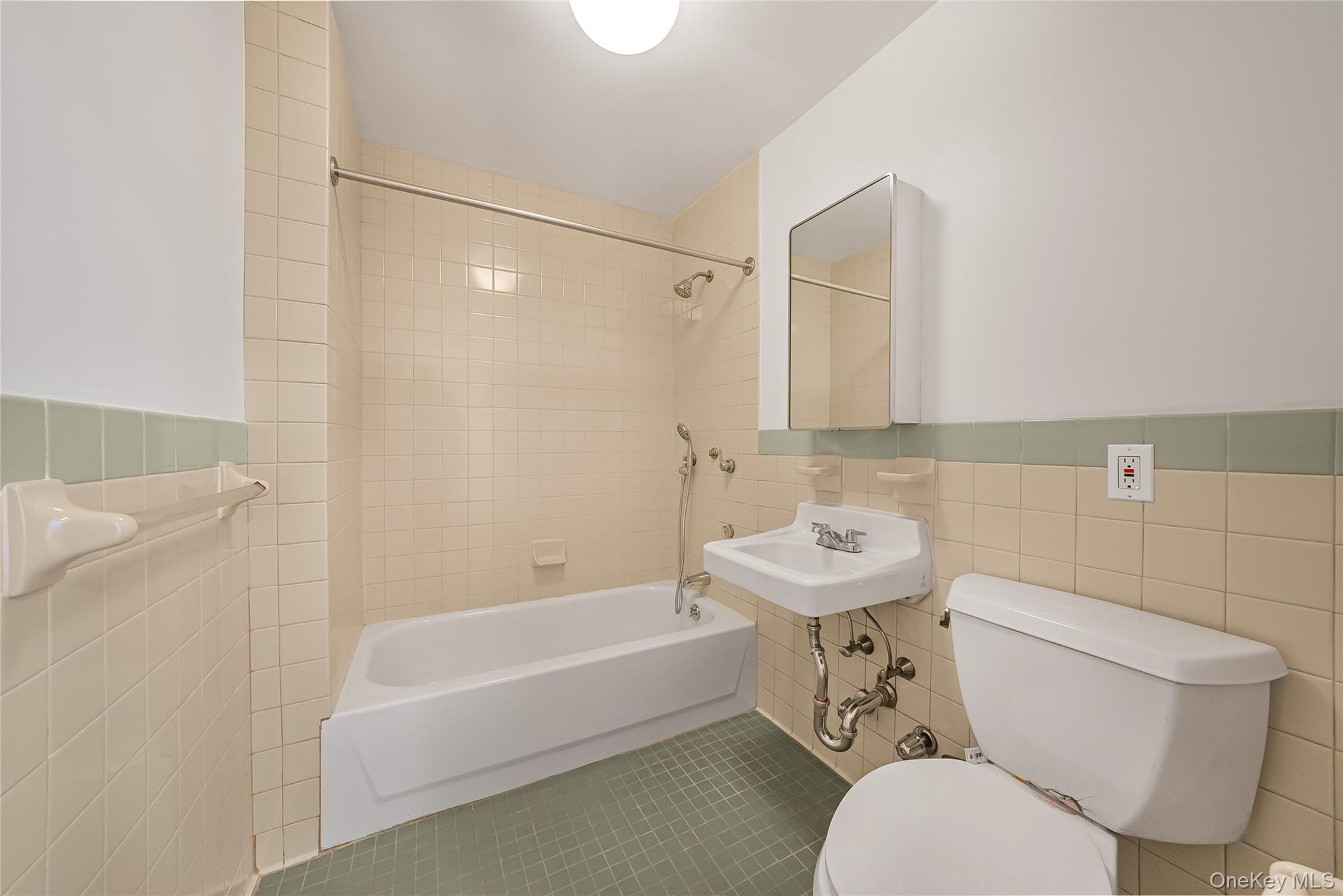 17 East 131st Street, Unit 1A Manhattan, NY 10037 - Photo 12 of 14 a bathroom with a sink mirror bathtub and toilet