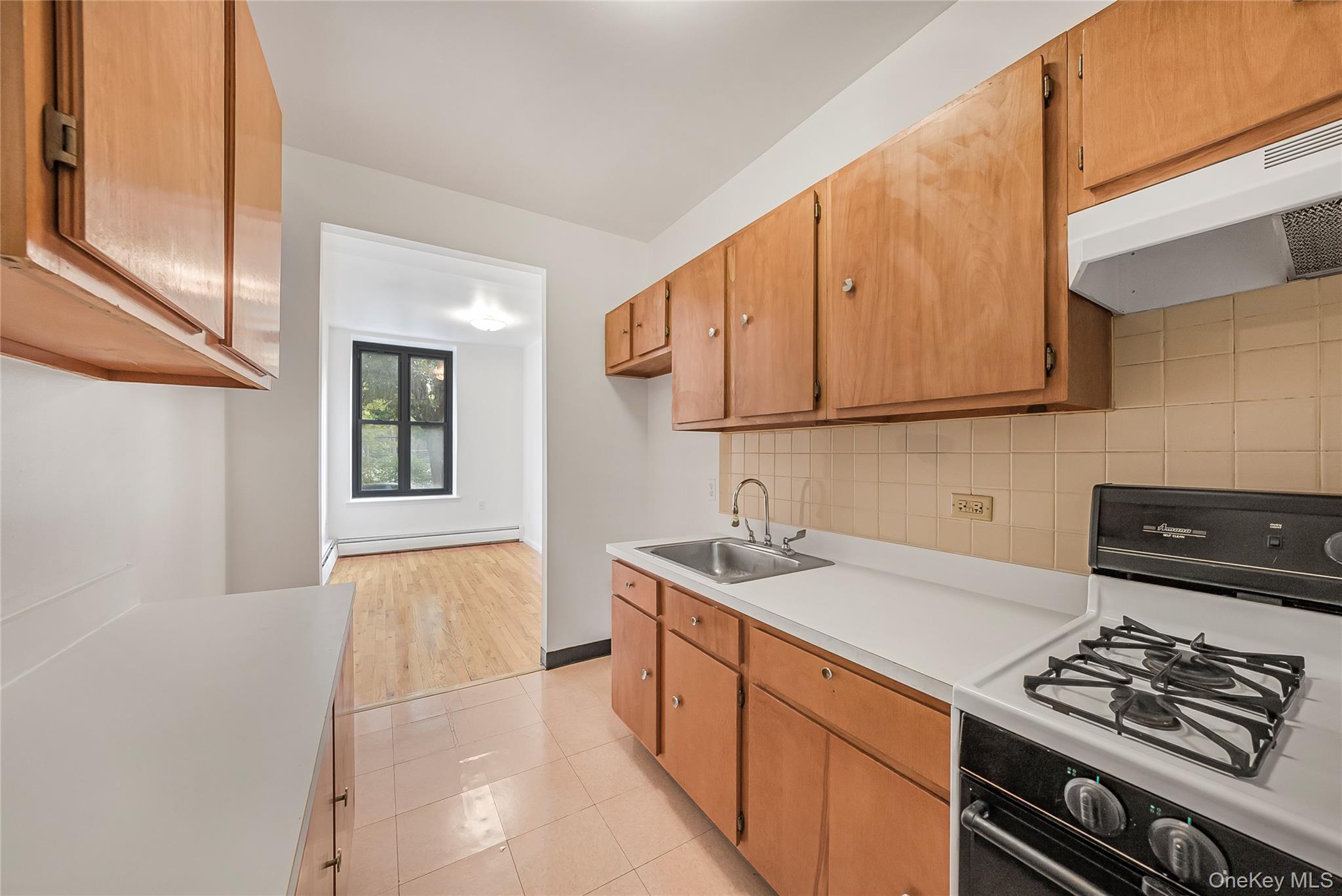 17 East 131st Street, Unit 1A Manhattan, NY 10037 - Photo 5 of 14 a kitchen with stainless steel appliances granite countertop a sink stove and cabinets