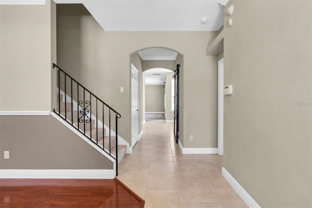 10121 Porch Street New Port Richey, FL 34655 - Photo 6 of 57 a view of a hallway with entryway wooden floor and front door