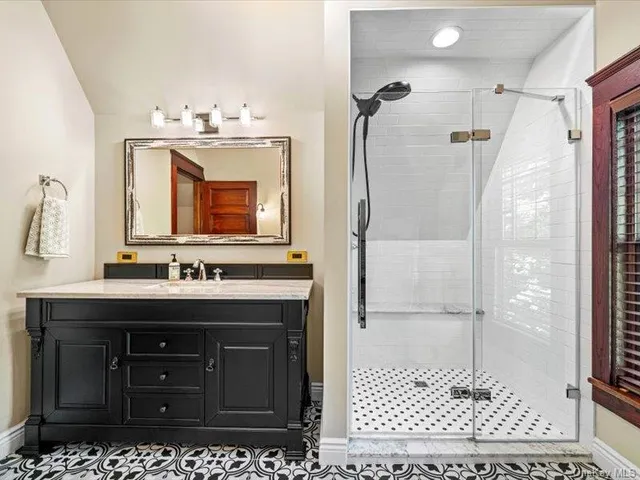 a bathroom with a sink a vanity and a mirror