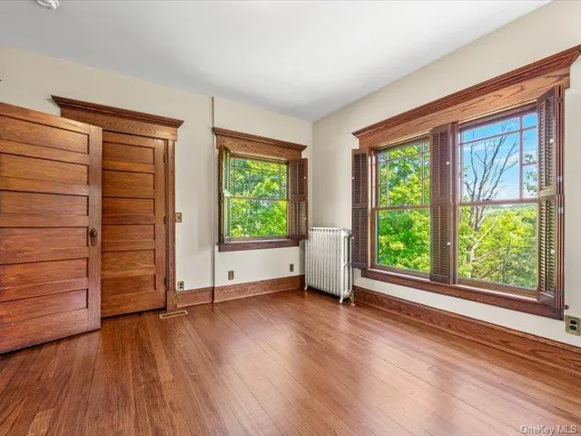 wooden floor in an empty room with a window