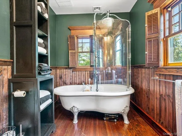 a dining room with a window and wooden floor