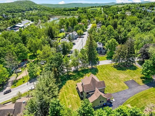 an aerial view of residential house with outdoor space and swimming pool