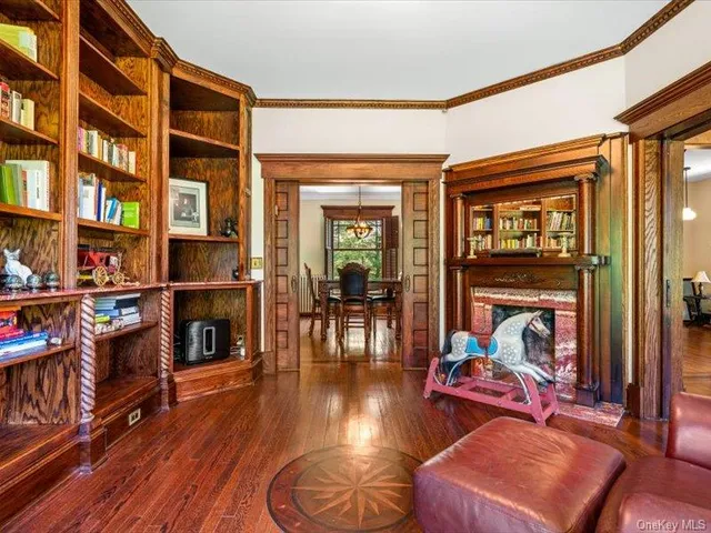 a living room with wooden floor and a fireplace