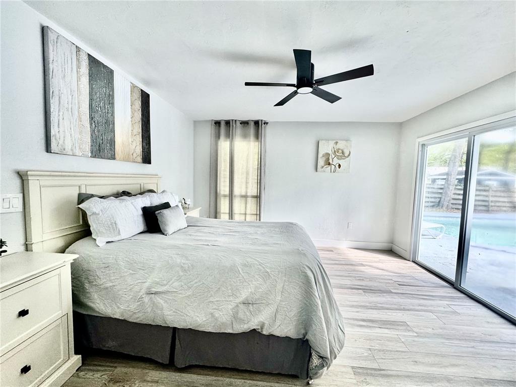 5407 Southwest 82 Terrace Gainesville, FL 32608 - Photo 14 of 31 a bedroom with a large bed and a window