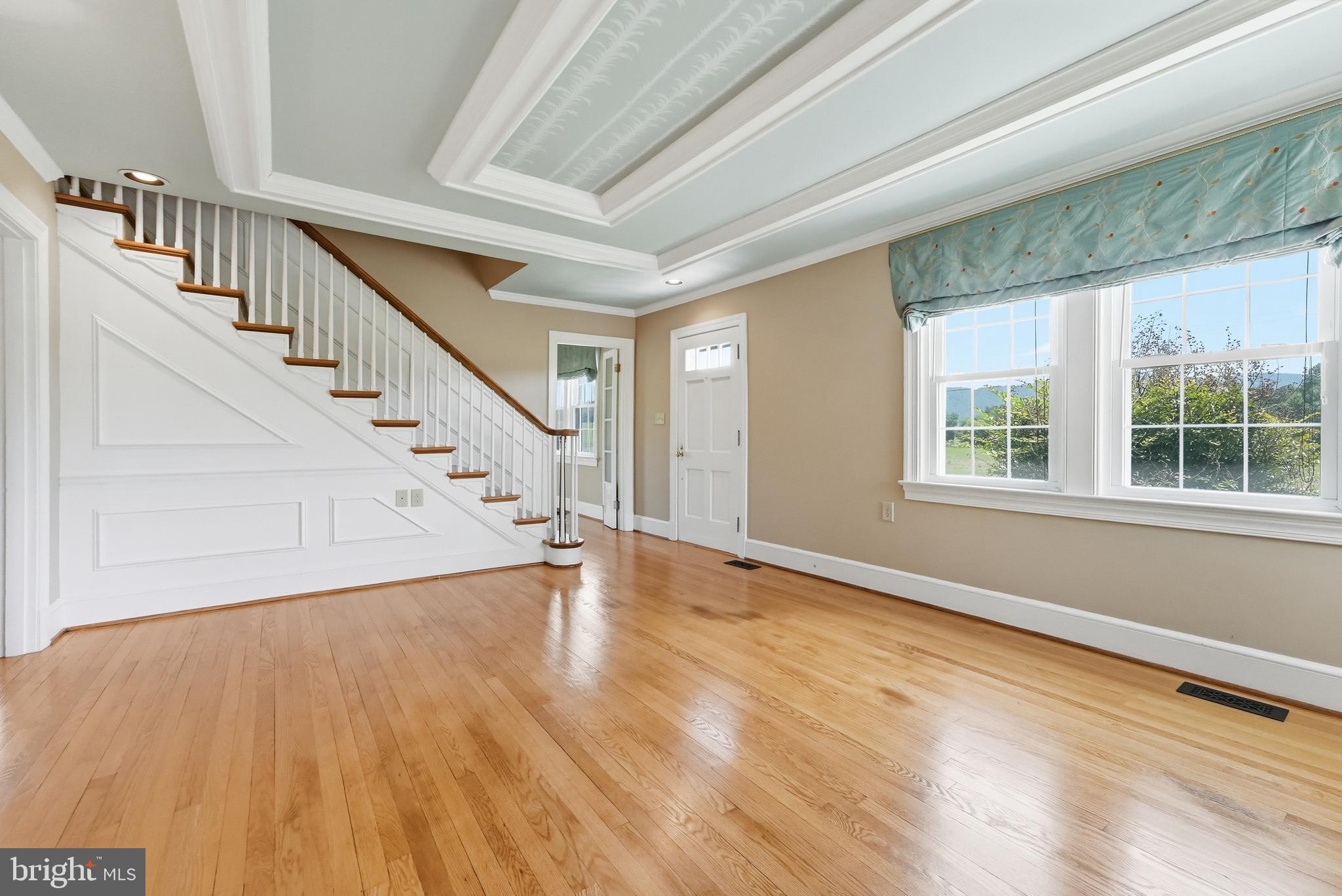 6117 South F T Valley Road Etlan, VA 22719 - Photo 10 of 36 Living room w/ large windows and beautiful stairs