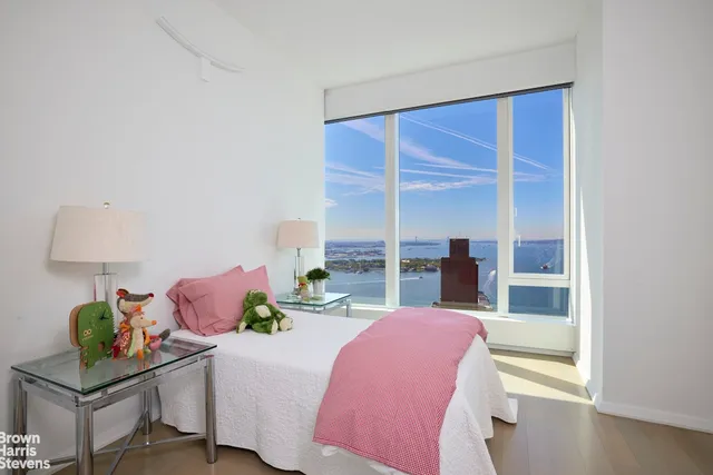 a bedroom with a bed and a table