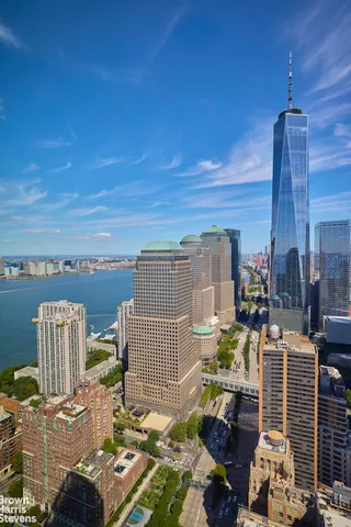an aerial view of a swimming pool with lawn chairs