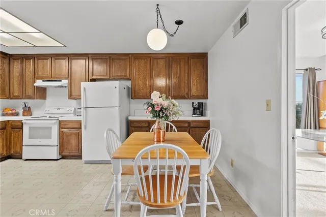 a kitchen with refrigerator a stove a sink and a refrigerator