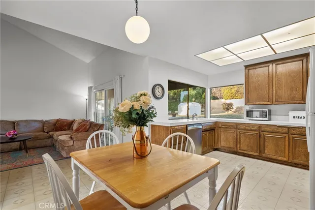 a view of a dining table chairs and kitchen