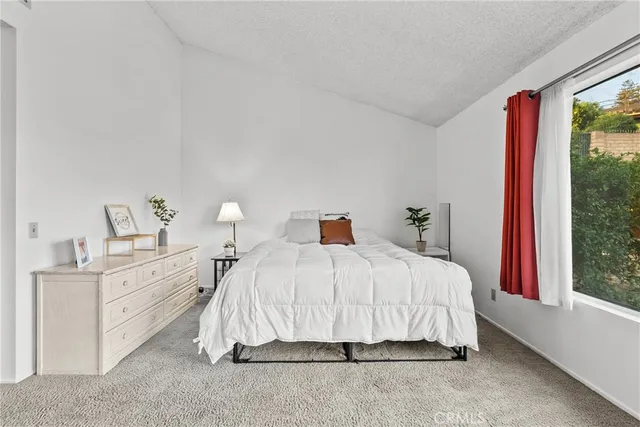 a bedroom with a bed and window
