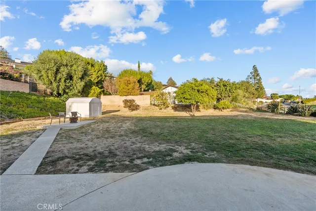 a view of a yard with cars parked