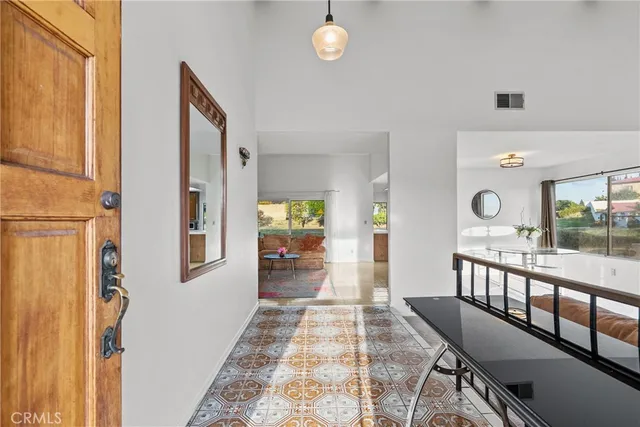 a view of a hallway with furniture and windows