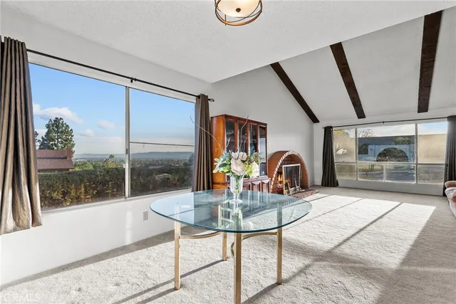 a dining room with furniture and a floor to ceiling window