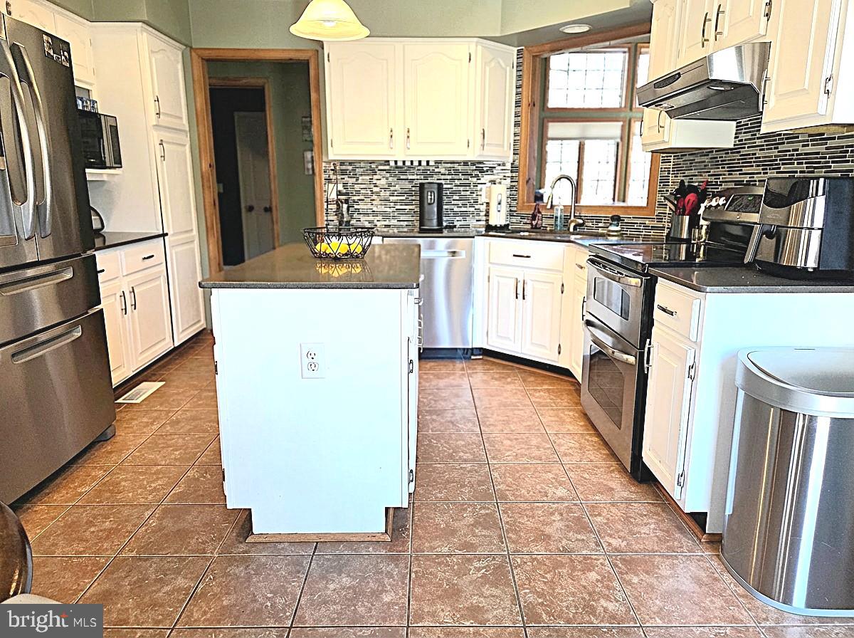 5632 Galestown - Reliance Road Rhodesdale, MD 21659 - Photo 16 of 30 a kitchen with stainless steel appliances a refrigerator sink and cabinets