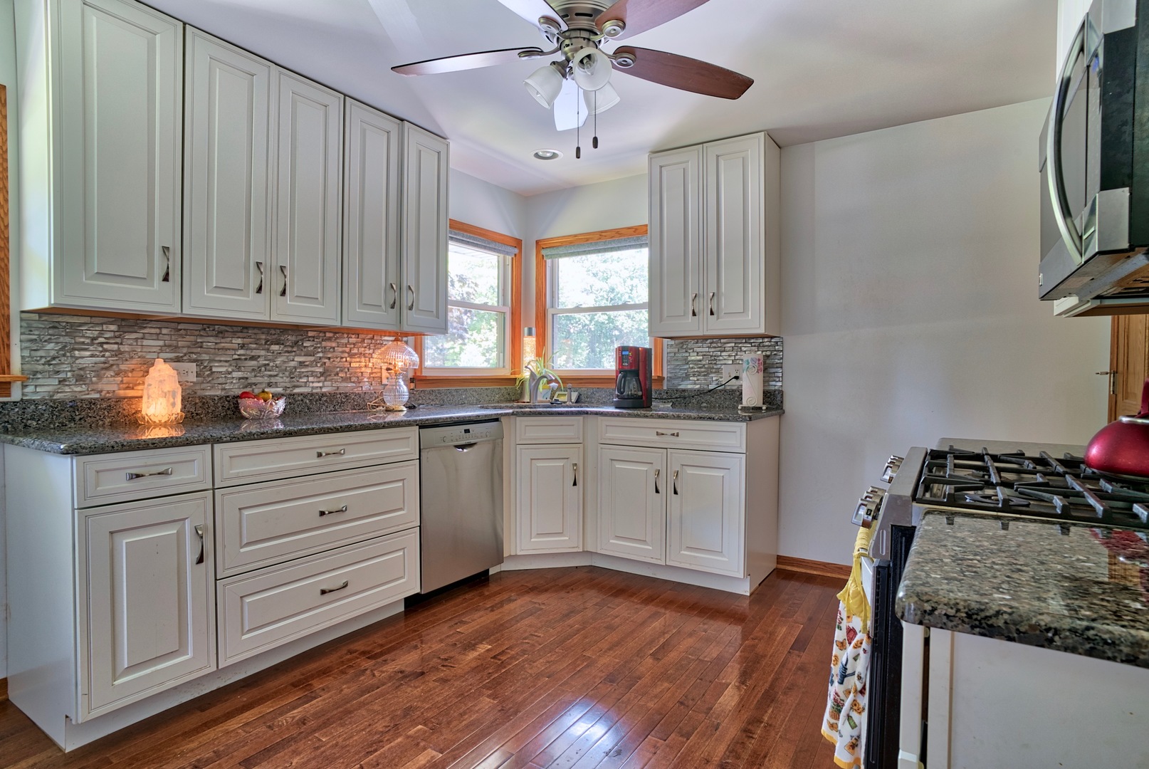 S703 Winfield Road Wheaton, IL 60189 - Photo 2 of 17 a kitchen with granite countertop white cabinets stainless steel appliances a sink and a window