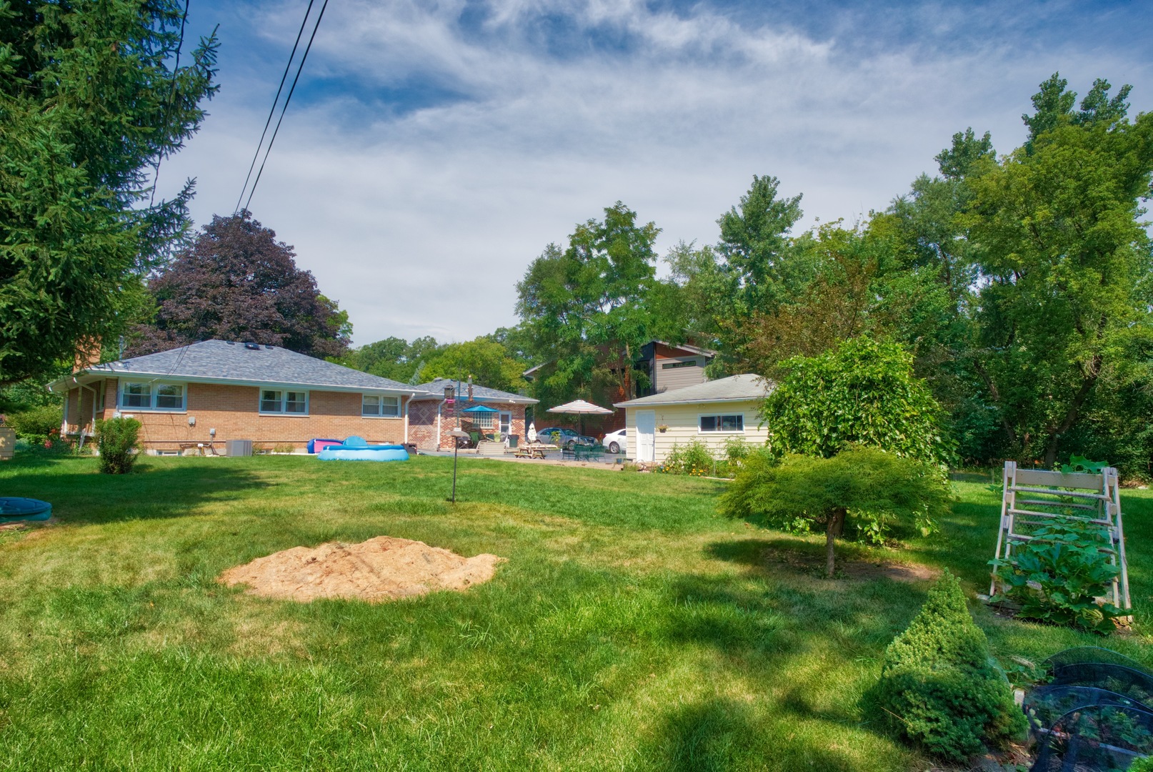 S703 Winfield Road Wheaton, IL 60189 - Photo 13 of 17 a front view of a house with a yard and trees