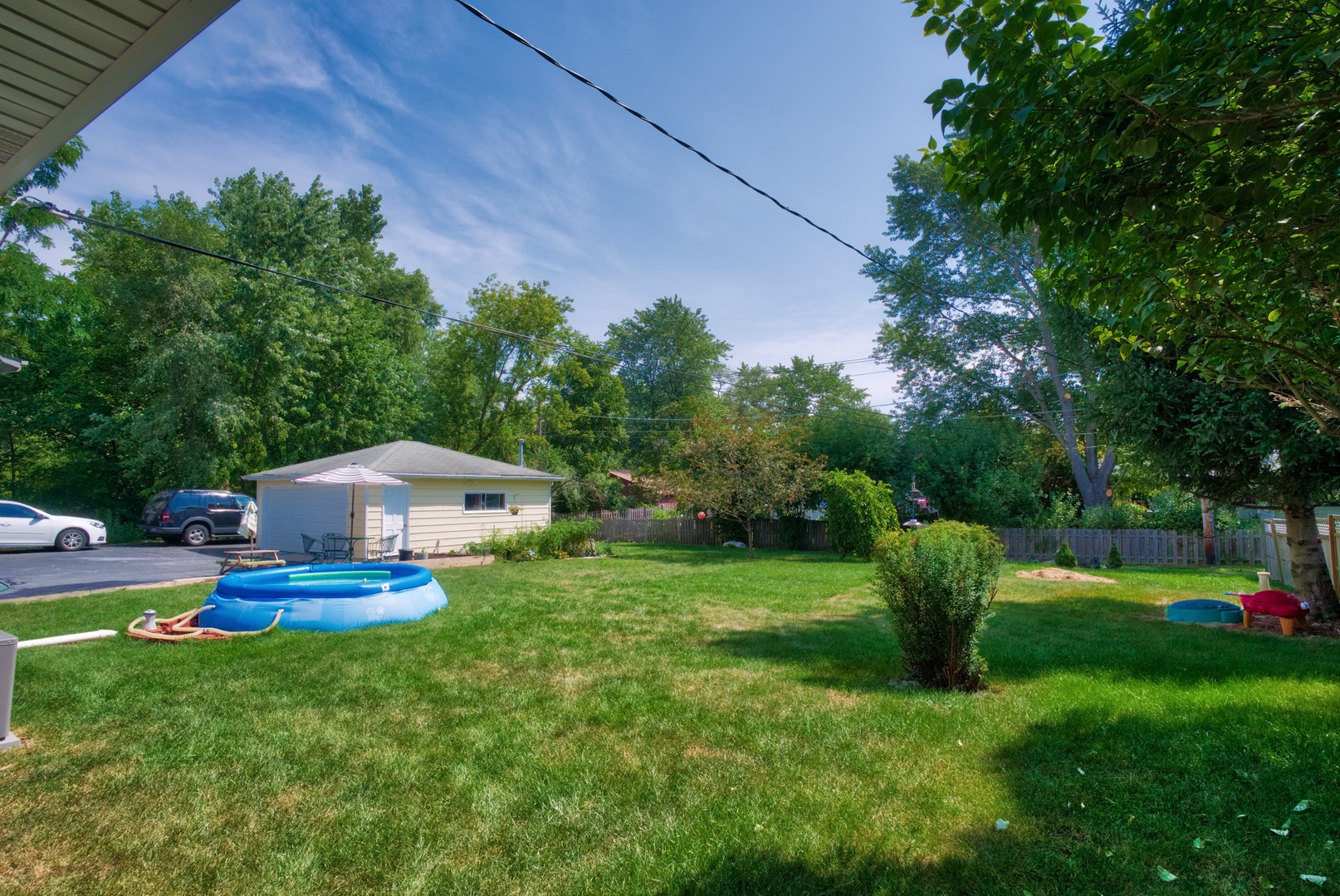 S703 Winfield Road Wheaton, IL 60189 - Photo 14 of 17 a front view of a house with a yard and trees