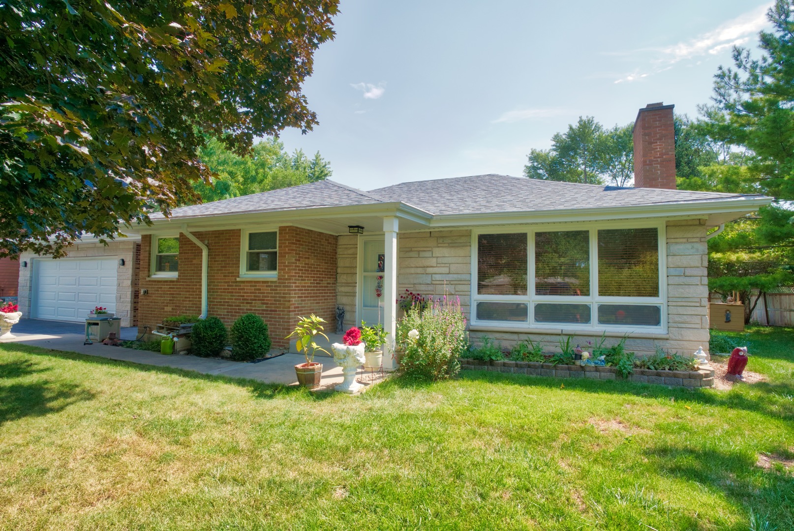 S703 Winfield Road Wheaton, IL 60189 - Photo 17 of 17 a front view of a house with garden