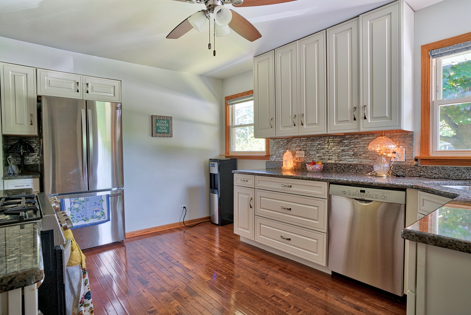 S703 Winfield Road Wheaton, IL 60189 - Photo 3 of 17 a kitchen with granite countertop wooden floors stainless steel appliances and a window