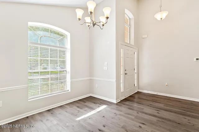 a kitchen with stainless steel appliances granite countertop wooden floor a stove a sink and a refrigerator