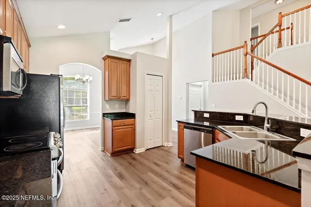 a kitchen with stainless steel appliances a sink stove and cabinets