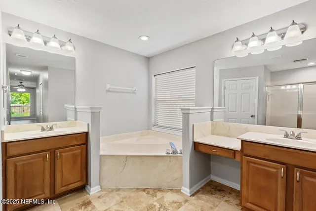 an empty room with wooden floor ceiling fan and windows