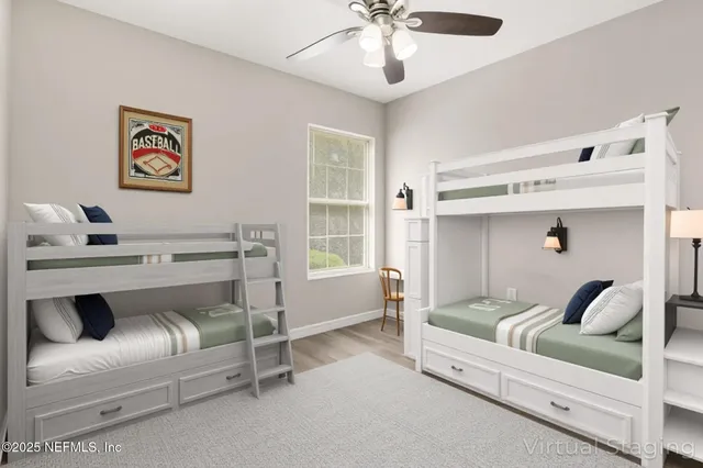 an empty room with wooden floor and ceiling fan