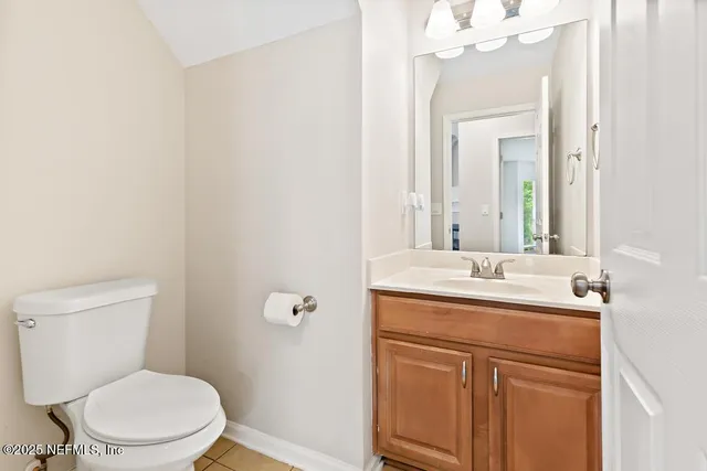 a view of a yard in front of a house with large trees