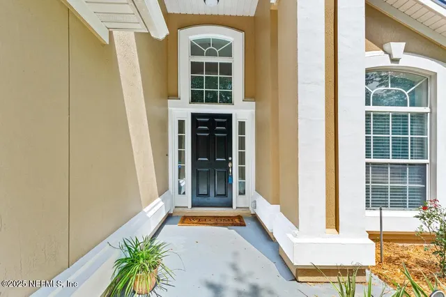 a living room with furniture a fireplace and a large window