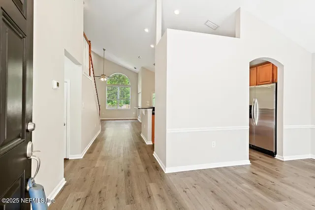 a view of an empty room with a fireplace and a window